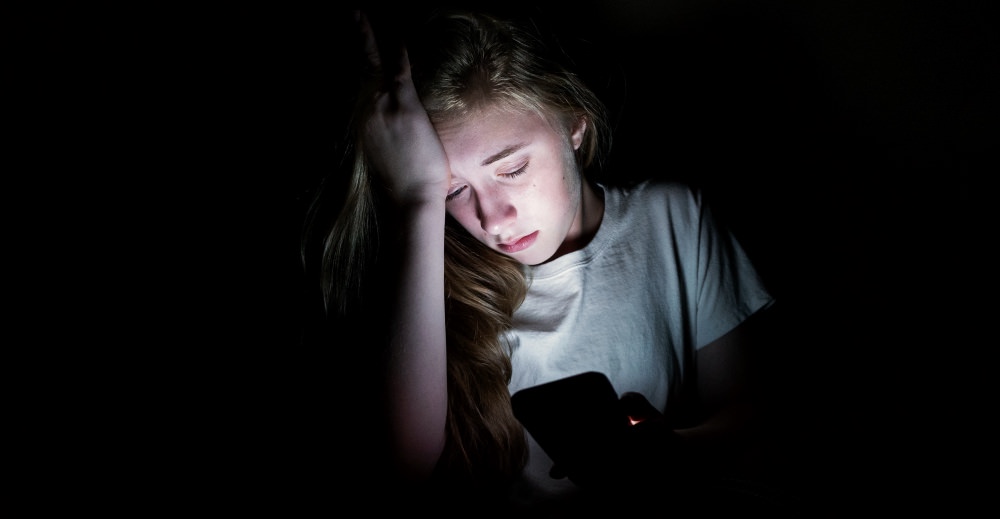 child-self-generated-explicit-content-girl-sad-dark-phone